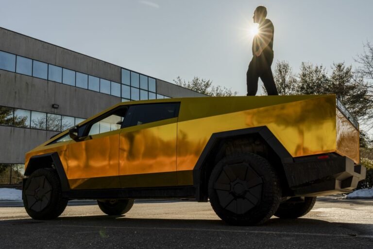 Kumait Jaroje on top of his gold Tesla Cybertruck outside his office in Southborough, Mass., March 2, 2025. (Sophie Park/The New York Times)